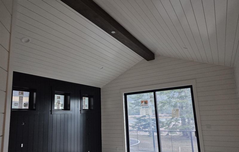 Black board-and-batten under a shiplap ceiling